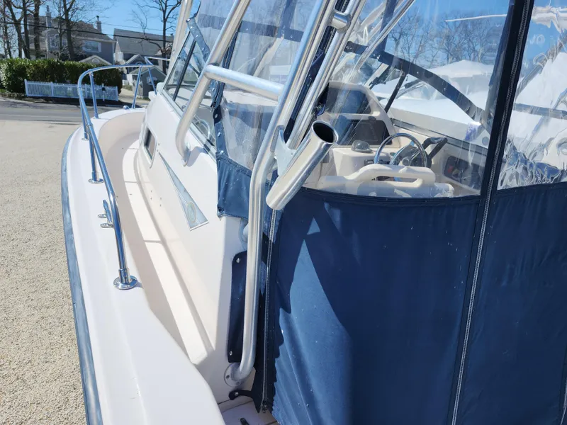 Slide: The Image of 2006 Grady-White Journey 258 boat with blue canopy and stainless steel railings. - 8