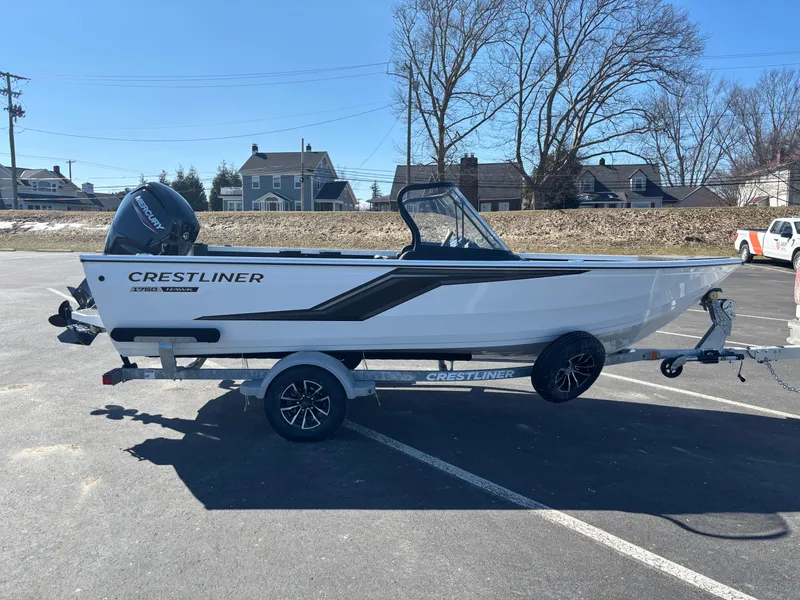 The Image of 2025 Crestliner 1750 Hawk boat on trailer in sunny parking lot. - 0