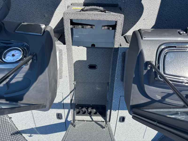 Slide: The Image of 2025 Crestliner 1750 Hawk boat interior with storage compartments and dashboard details. - 13