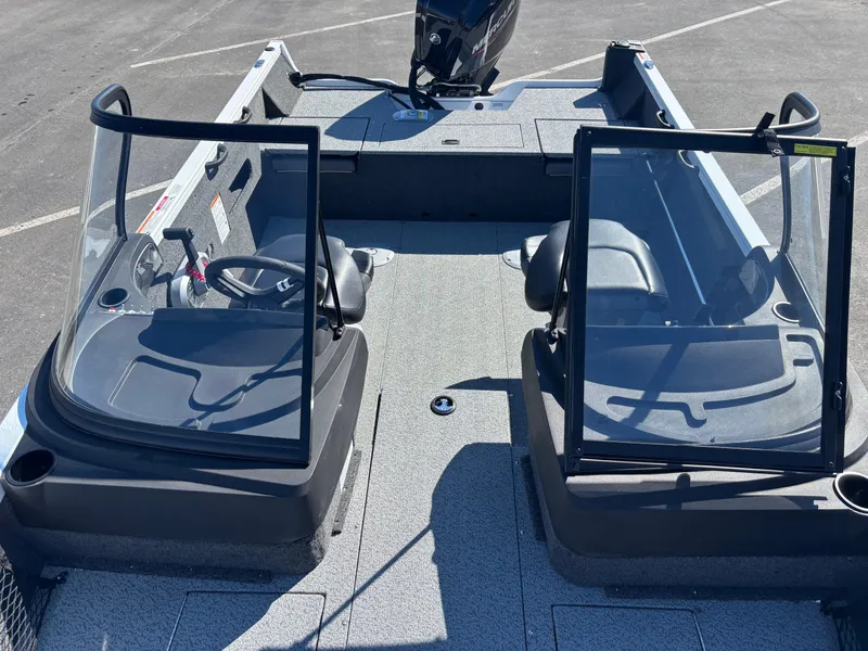 Slide: The Image of 2025 Crestliner 1750 Hawk boat interior with dual consoles and seating. - 2