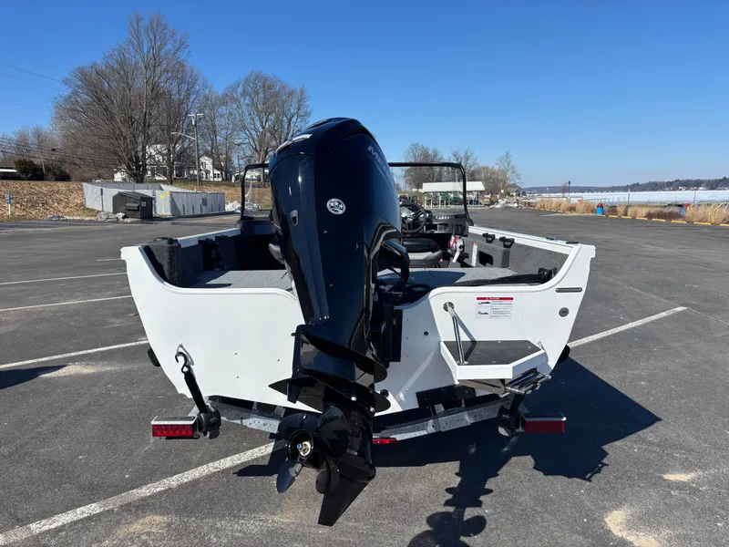 Slide: The Image of 2025 Crestliner 1750 Hawk boat with outboard motor in a parking lot. - 5