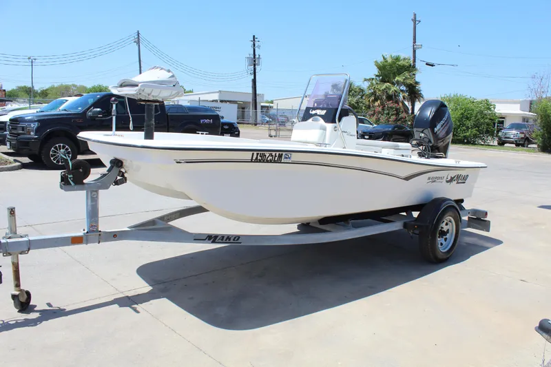 Slide: The Image of 2019 Mako Pro Skiff 15 CC boat on trailer in parking lot. - 3