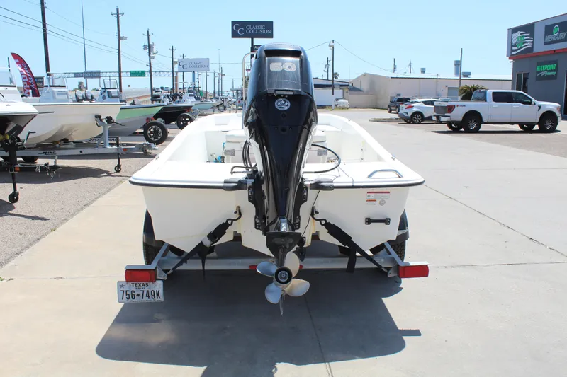 Slide: The Image of 2019 Mako Pro Skiff 15 CC boat on trailer, rear view in outdoor dealership. - 6