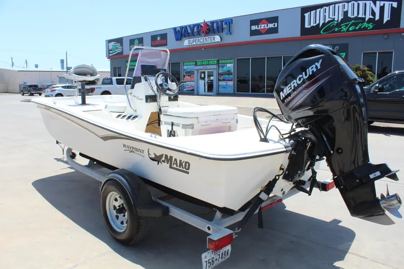 Slide: The Image of 2019 Mako Pro Skiff 15 CC with Mercury outboard, parked outside dealership. - 7