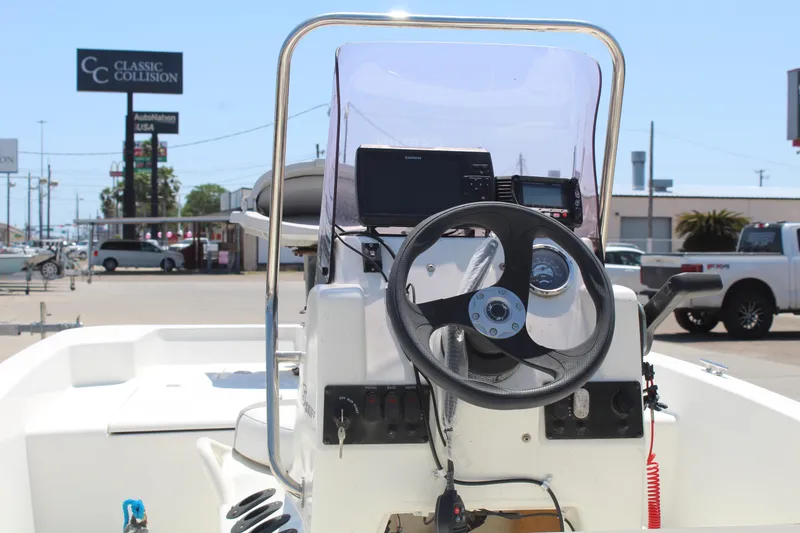 Slide: The Image of 2019 Mako Pro Skiff 15 CC boat console with steering wheel and navigation equipment. - 8