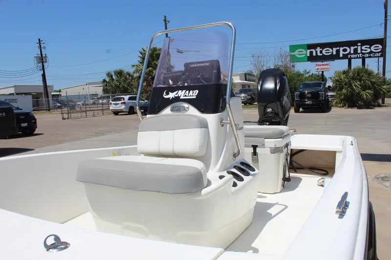 Slide: The Image of 2019 Mako Pro Skiff 15 CC boat with seating and motor, parked outdoors. - 9