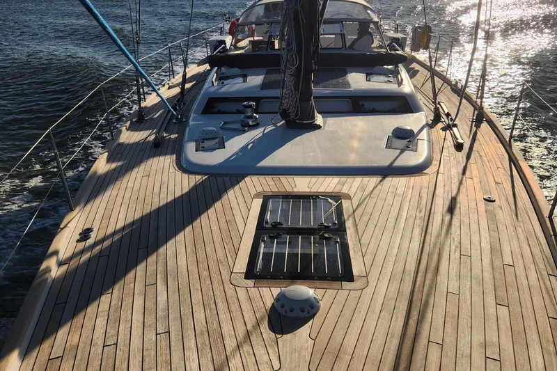 Slide: The Image of 2023 Hallberg-Rassy 57 yacht deck with sleek design and wooden finish. - 11
