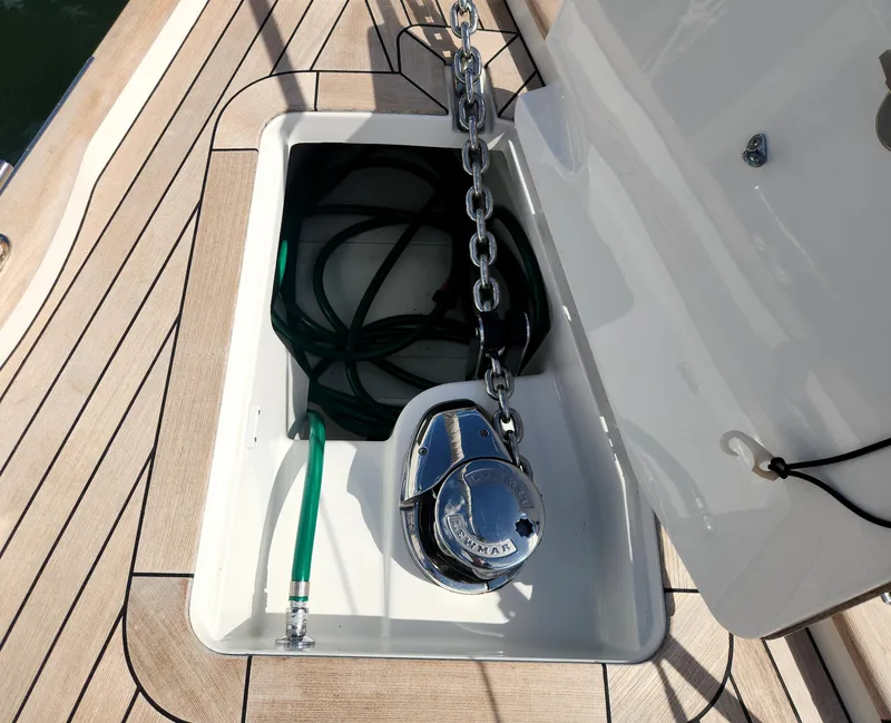 Slide: The Image of Anchor locker on 2023 Hallberg-Rassy 57 yacht with chain and hose. - 16