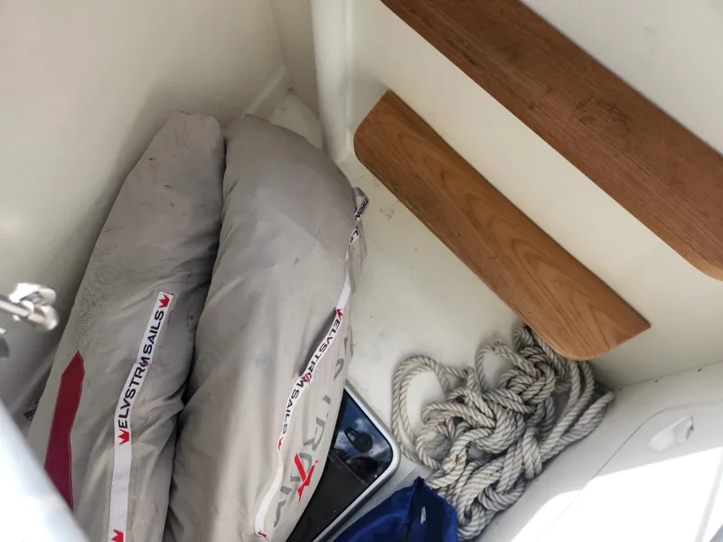 Slide: The Image of Storage area on a 2023 Hallberg-Rassy 57 yacht with sails and coiled rope. - 18