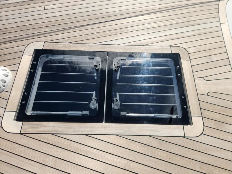 Slide: The Image of 2023 Hallberg-Rassy 57 yacht deck with dual skylights and teak finish. - 19