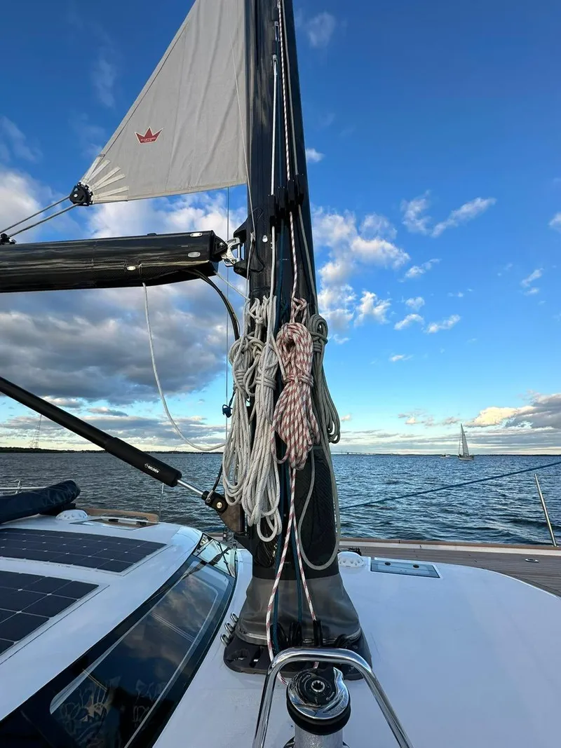 Slide: The Image of 2023 Hallberg-Rassy 57 sailboat mast and rigging against a clear blue sky. - 27