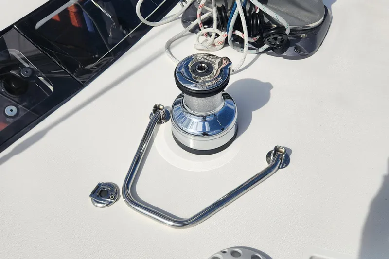 Slide: The Image of Deck winch on 2023 Hallberg-Rassy 57 yacht, featuring sleek chrome finish and rigging. - 28