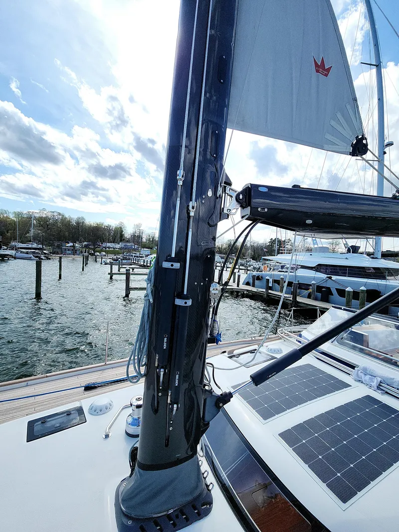Slide: The Image of 2023 Hallberg-Rassy 57 yacht with solar panels and mast, docked at a marina. - 31