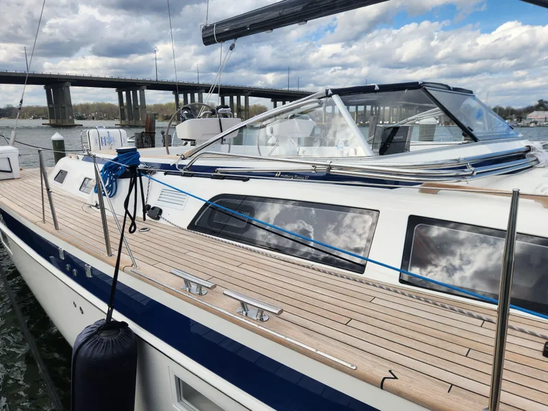 Slide: The Image of 2023 Hallberg-Rassy 57 yacht docked, showcasing sleek design and spacious deck. - 35