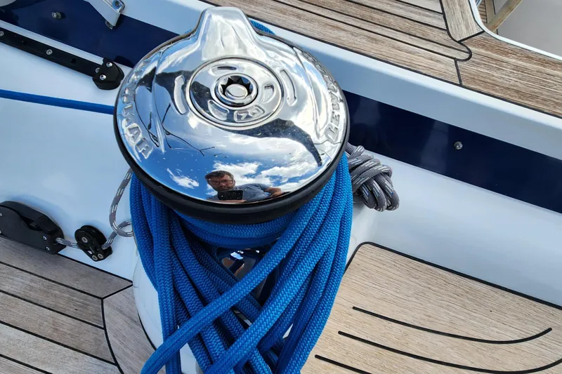 Slide: The Image of 2023 Hallberg-Rassy 57 yacht winch with blue ropes on teak deck. - 40