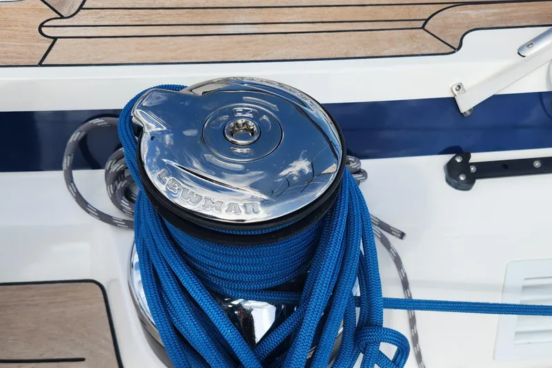 Slide: The Image of Winch with blue rope on 2023 Hallberg-Rassy 57 yacht deck. - 41