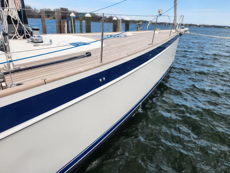 Slide: The Image of 2023 Hallberg-Rassy 57 yacht docked, showcasing sleek design and craftsmanship. - 6