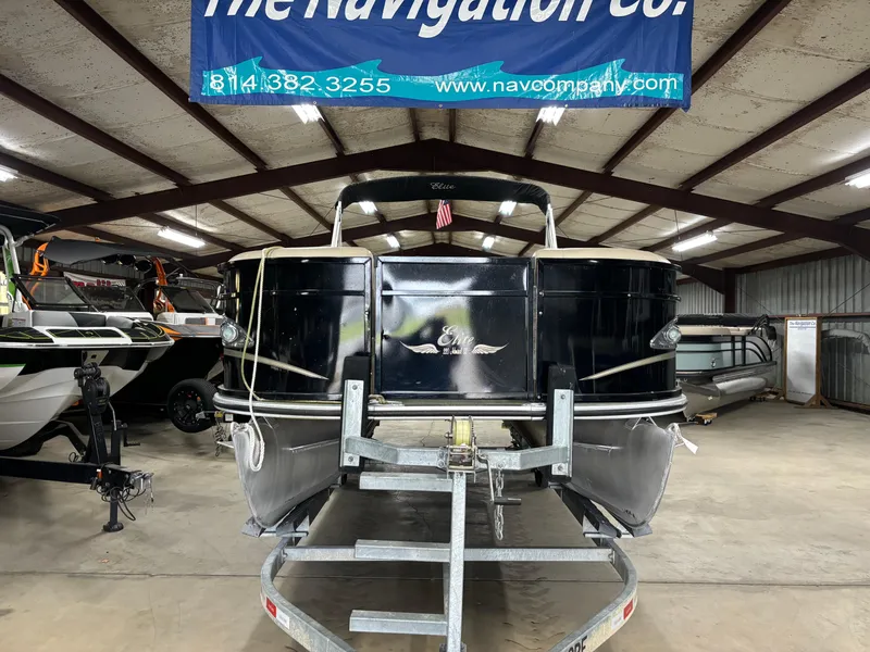 Slide: The Image of 2017 Bentley Pontoons 220 Elite Admiral in showroom, on trailer, under "The Navigation Co." sign. - 11