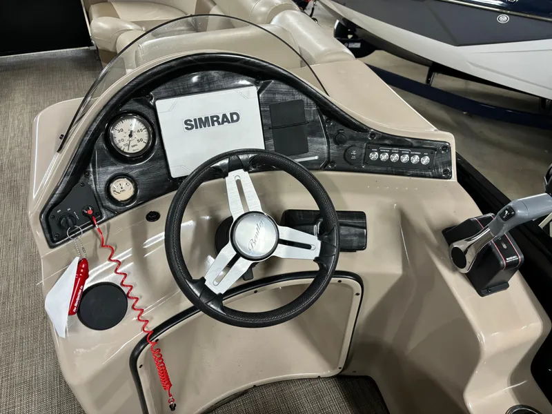 Slide: The Image of 2017 Bentley Pontoons 220 Elite Admiral dashboard with steering wheel and Simrad display. - 2