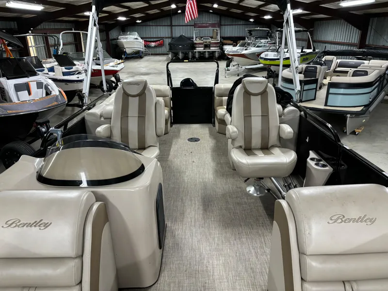Slide: The Image of 2017 Bentley Pontoons 220 Elite Admiral interior with luxurious seating in a showroom. - 3