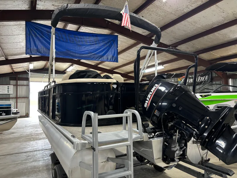 Slide: The Image of 2017 Bentley Pontoons 220 Elite Admiral with Suzuki outboard in a storage facility. - 6