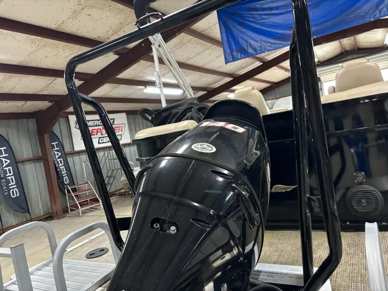 Slide: The Image of 2017 Bentley Pontoons 220 Elite Admiral in a storage facility, showcasing the motor and seating. - 7