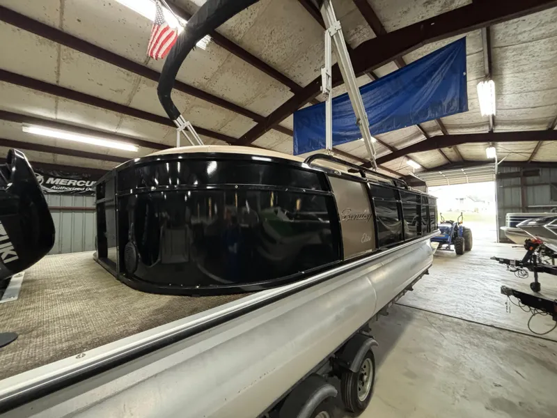 Slide: The Image of 2017 Bentley Pontoons 220 Elite Admiral in a warehouse, showcasing sleek black design. - 9