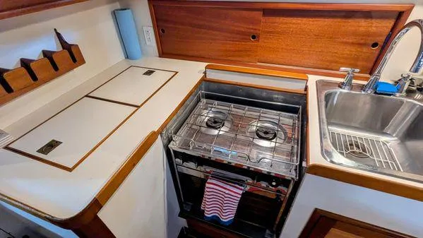 Slide: The Image of Compact kitchen area in a 1990 Stanley 36' Downeast Fly Bridge Cruise boat. - 24