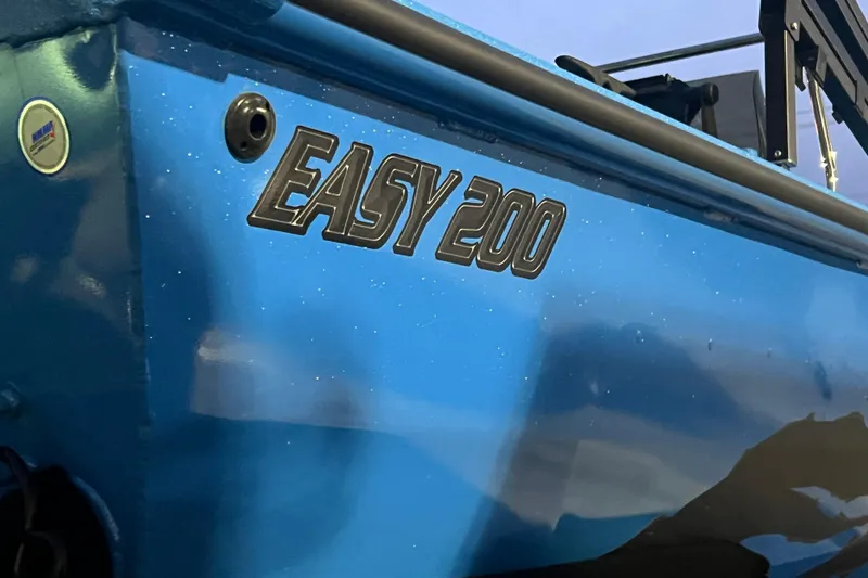 Slide: The Image of 2025 SeaArk Easy 200 boat, blue exterior with model name displayed. - 14
