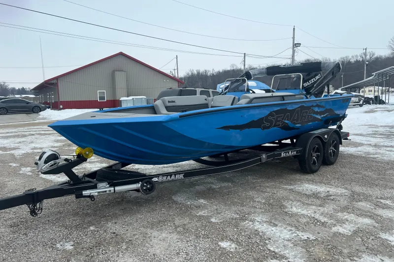 Slide: The Image of 2026 SeaArk Easy 200 boat on trailer, blue exterior, parked in snowy lot. - 16