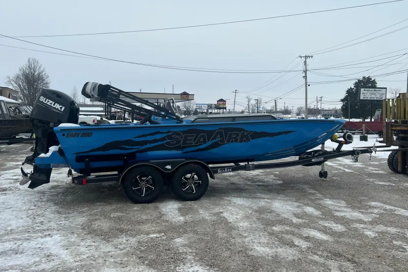 Slide: The Image of 2026 SeaArk Easy 200 boat with Suzuki motor on trailer in snowy outdoor setting. - 17
