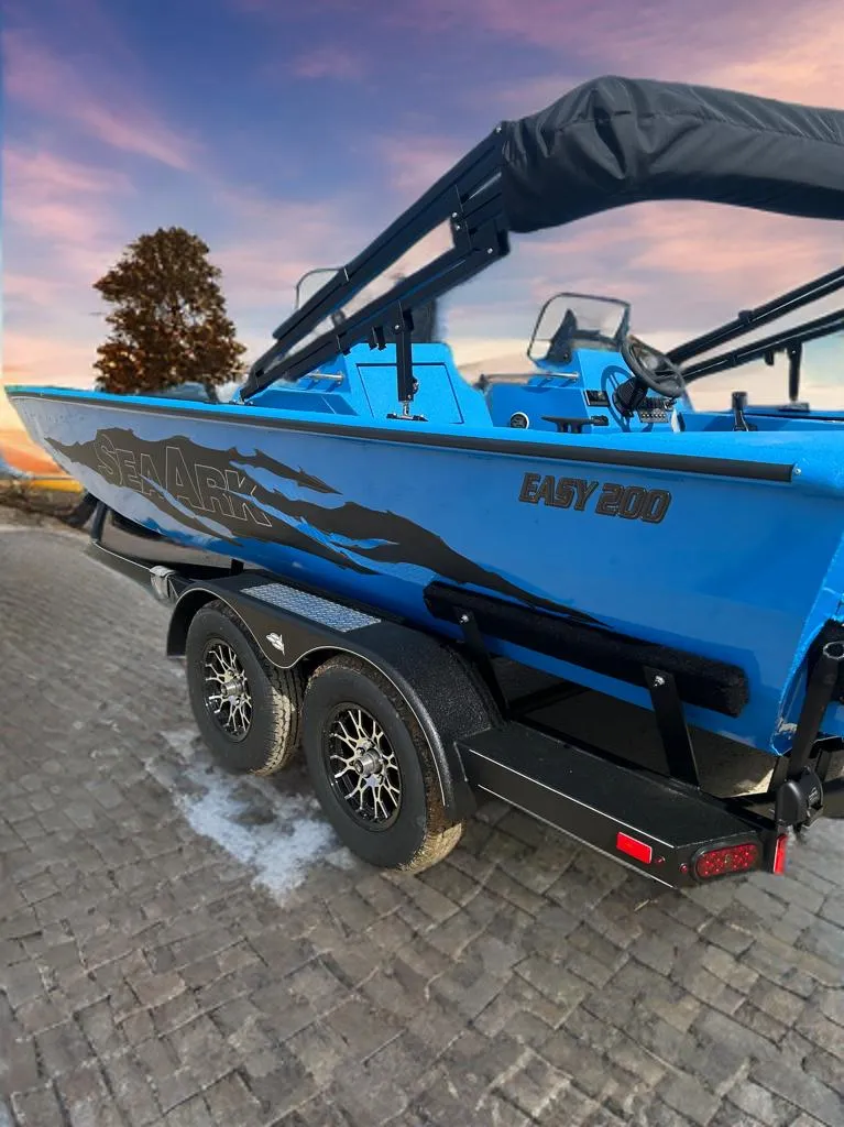Slide: The Image of 2026 SeaArk Easy 200 boat on trailer at sunset in desert landscape. - 2