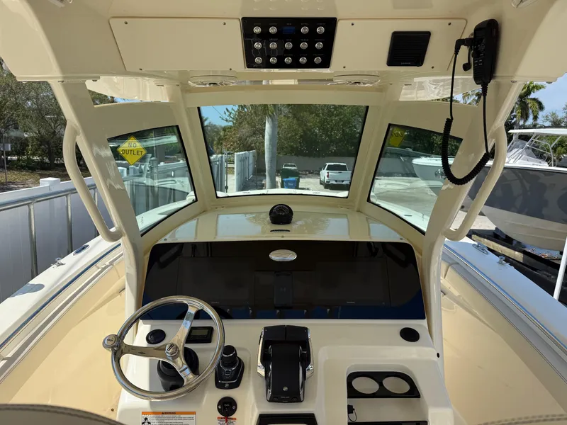 Slide: The Image of Helm of 2025 Scout 305 LXF boat with modern controls and steering wheel. - 10