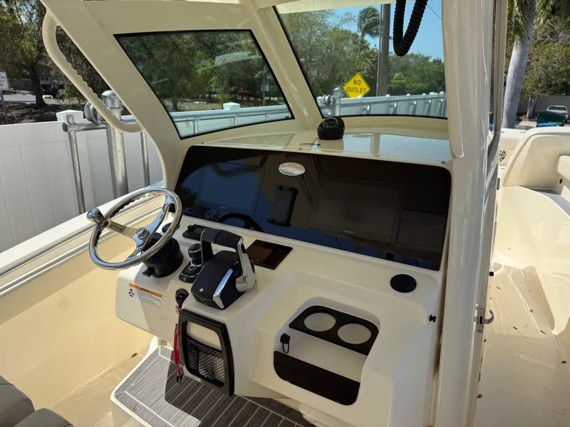 Slide: The Image of 2025 Scout 305 LXF boat cockpit with steering wheel and control panel. - 11