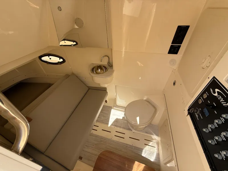 Slide: The Image of 2025 Scout 305 LXF interior with seating, sink, and toilet. - 22