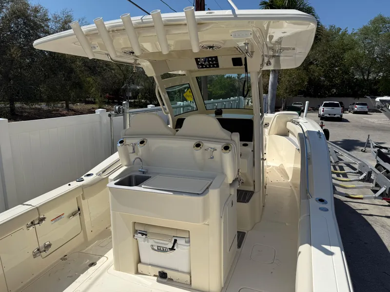 Slide: The Image of 2025 Scout 305 LXF boat interior with helm station and seating area. - 6