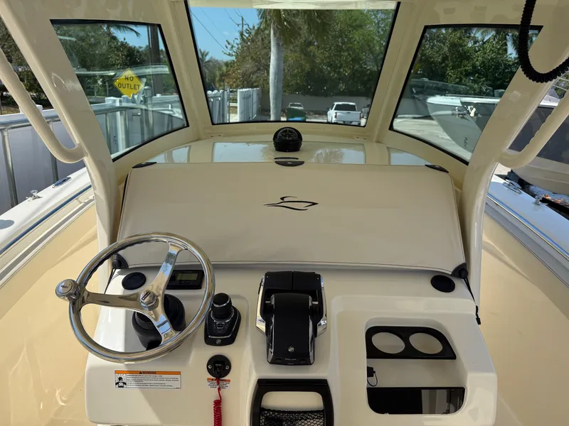 Slide: The Image of 2025 Scout 305 LXF boat dashboard with steering wheel and controls. - 9