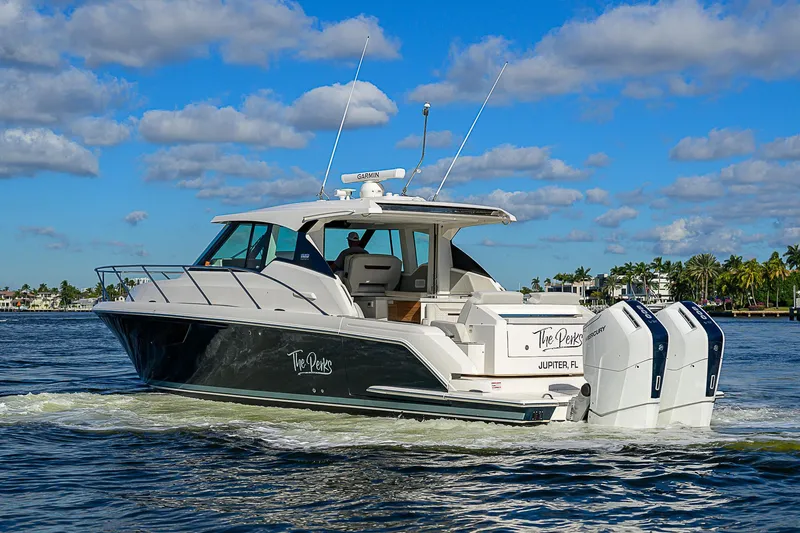 Slide: The Image of 2023 Tiara Yachts 43 LE cruising on a sunny day with blue skies. - 1