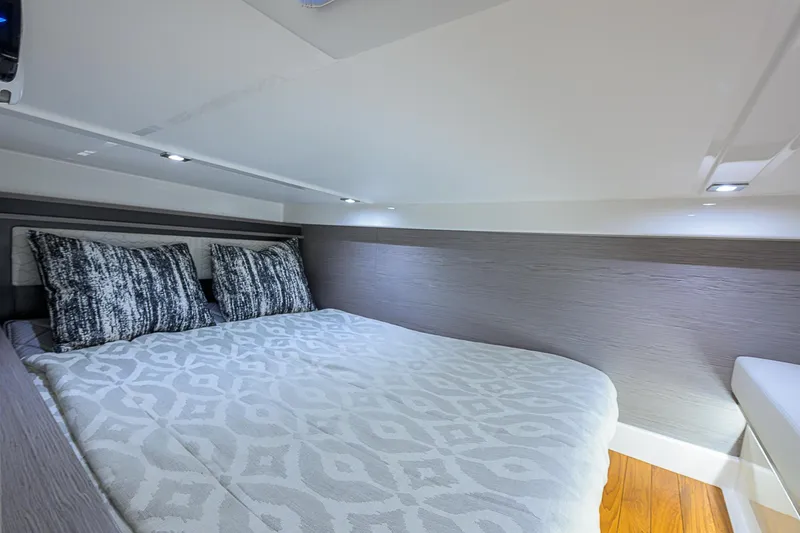 Slide: The Image of 2023 Tiara Yachts 43 LE cabin interior with cozy bed and modern design. - 47