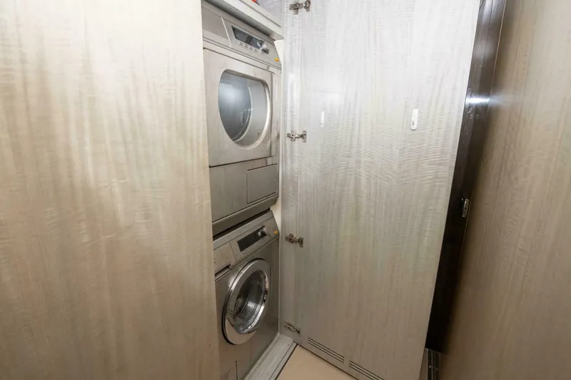 Slide: The Image of Laundry area with stacked washer and dryer in 2017 Azimut 84 Flybridge yacht. - 20