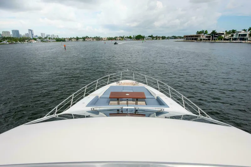 Slide: The Image of Azimut 84 Flybridge 2017 yacht cruising on a calm waterway with city skyline. - 31