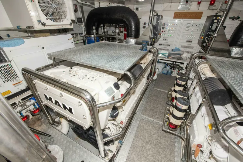 Slide: The Image of Engine room of 2017 Azimut 84 Flybridge yacht, featuring MAN engines and control panels. - 34