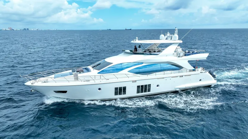 Slide: The Image of 2017 Azimut 84 Flybridge yacht cruising on open sea under blue sky. - 39