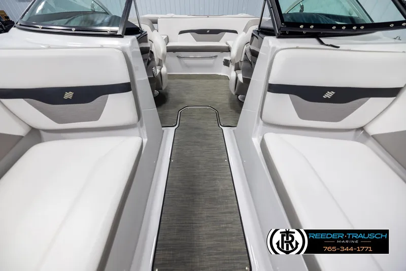Slide: The Image of 2019 Four Winns HD200 boat interior with white seating and gray flooring. - 16