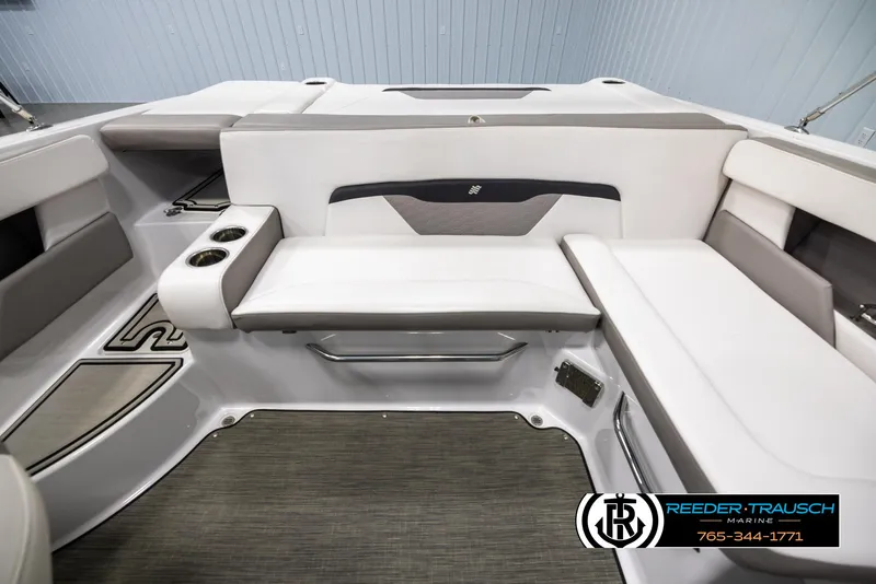 Slide: The Image of 2019 Four Winns HD200 boat interior with white seating and cup holders. - 18
