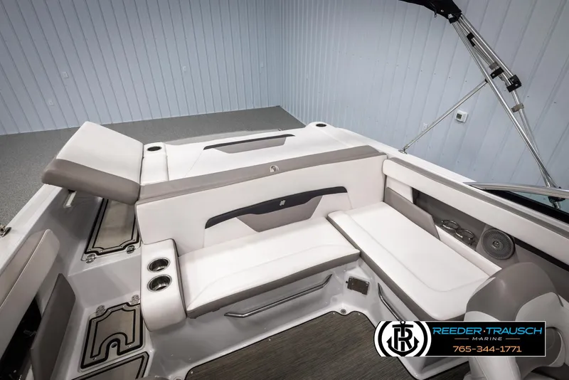 Slide: The Image of 2019 Four Winns HD200 boat interior with white seating and cup holders. - 22