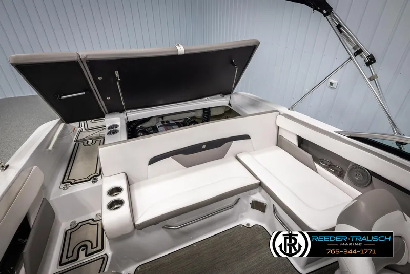 Slide: The Image of 2019 Four Winns HD200 boat interior with open engine compartment and seating area. - 23
