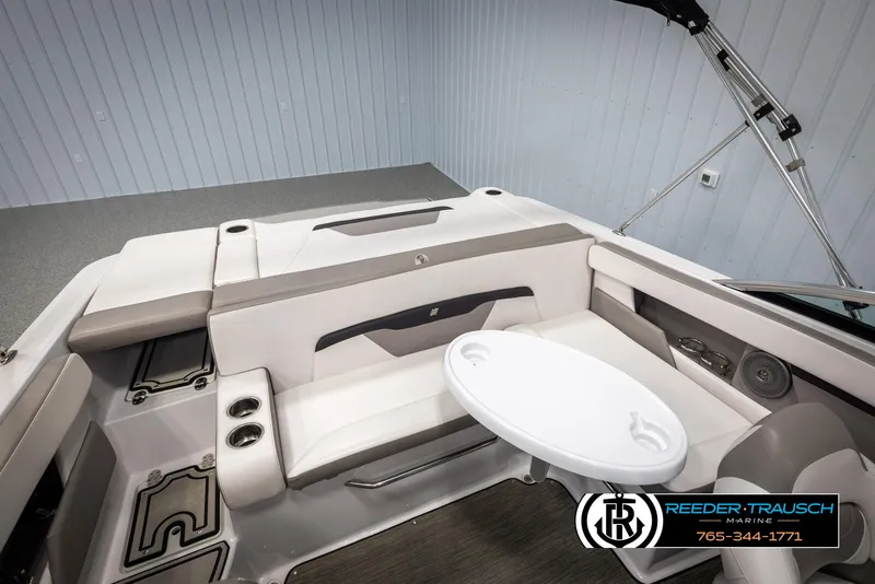 Slide: The Image of 2019 Four Winns HD200 boat interior with seating and table, Reeder-Trausch Marine logo visible. - 24