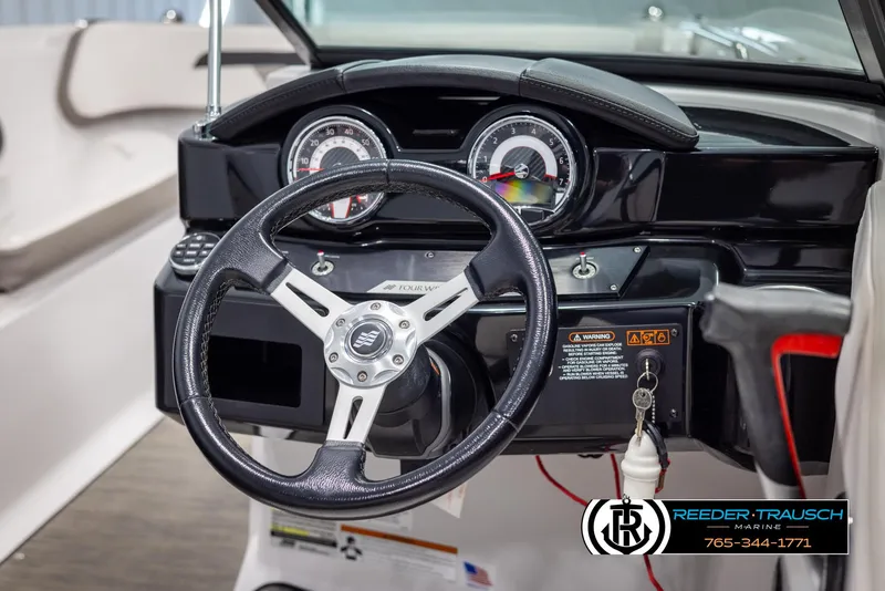 Slide: The Image of 2019 Four Winns HD200 boat dashboard with steering wheel and gauges. - 27