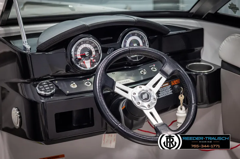 Slide: The Image of 2019 Four Winns HD200 boat dashboard with steering wheel and gauges. - 28